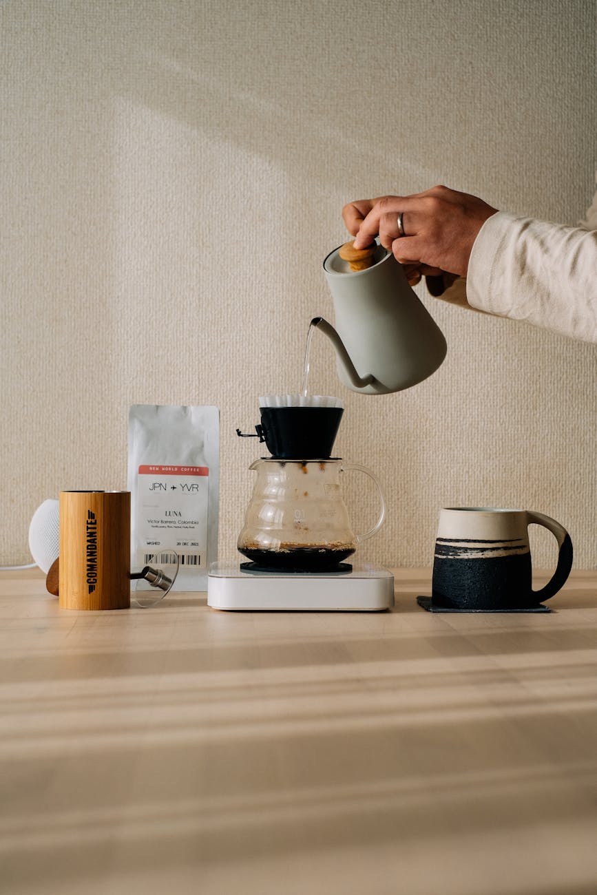 A side-by-side comparison of different manual brewing setups: a pour-over cone, a French press, and an Aeropress, each with their respective coffee ratios displayed.