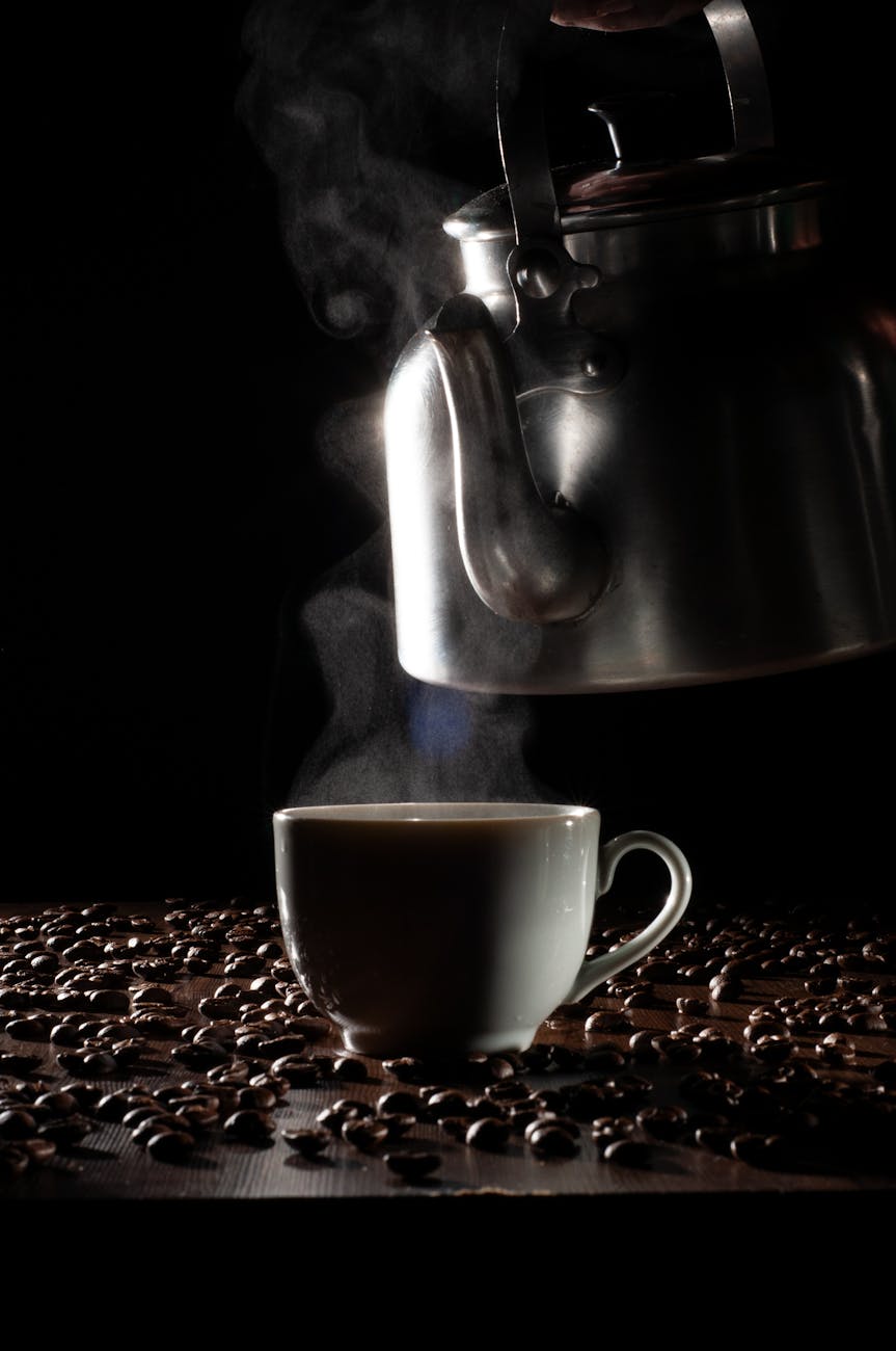 A perfectly brewed cup of coffee with a steaming kettle and coffee beans in the background, signifying the achievement of optimal coffee flavor through careful water management.