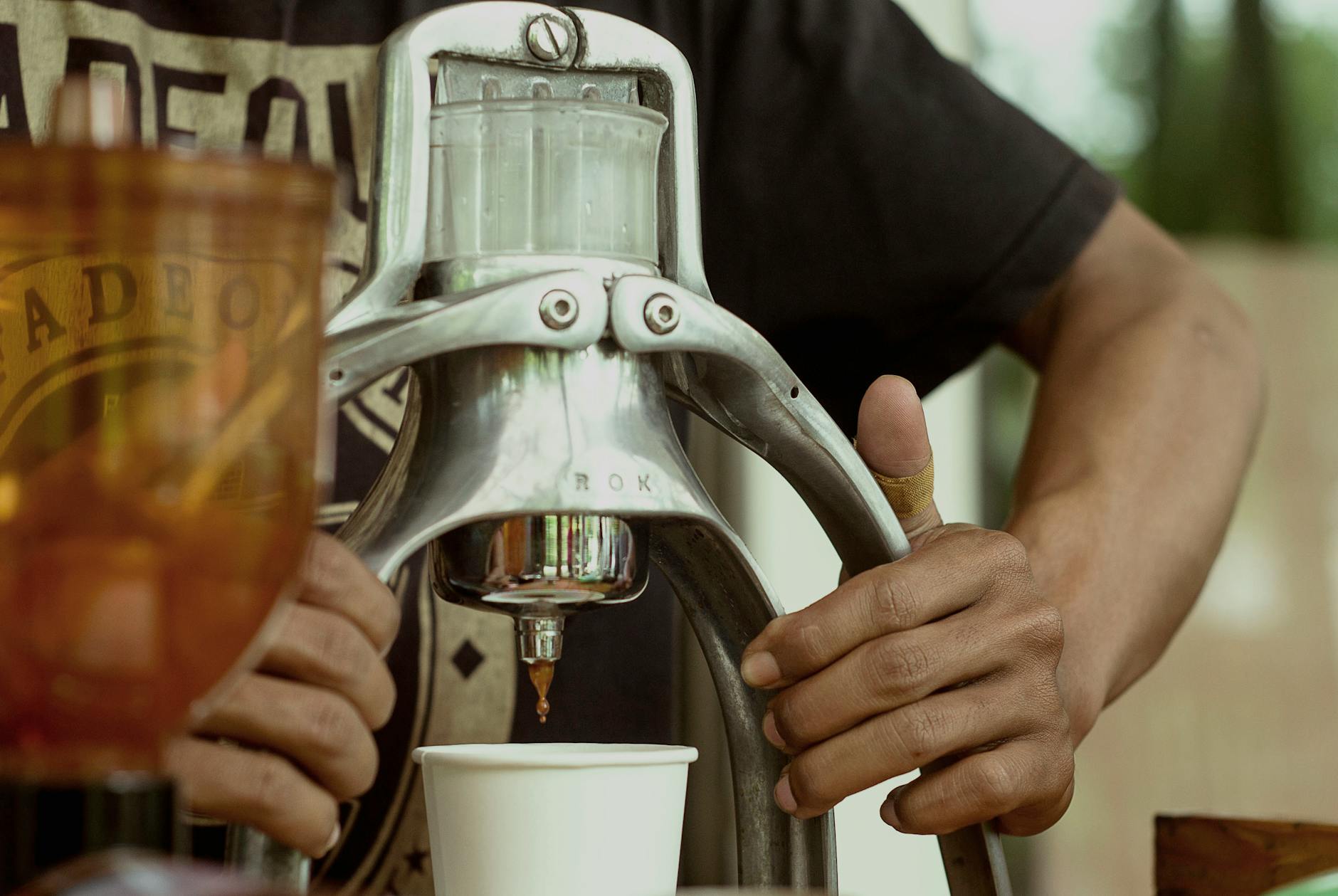 A side-by-side comparison of a manual pour-over setup, a drip coffee maker, and an espresso machine, highlighting their different environmental impacts.