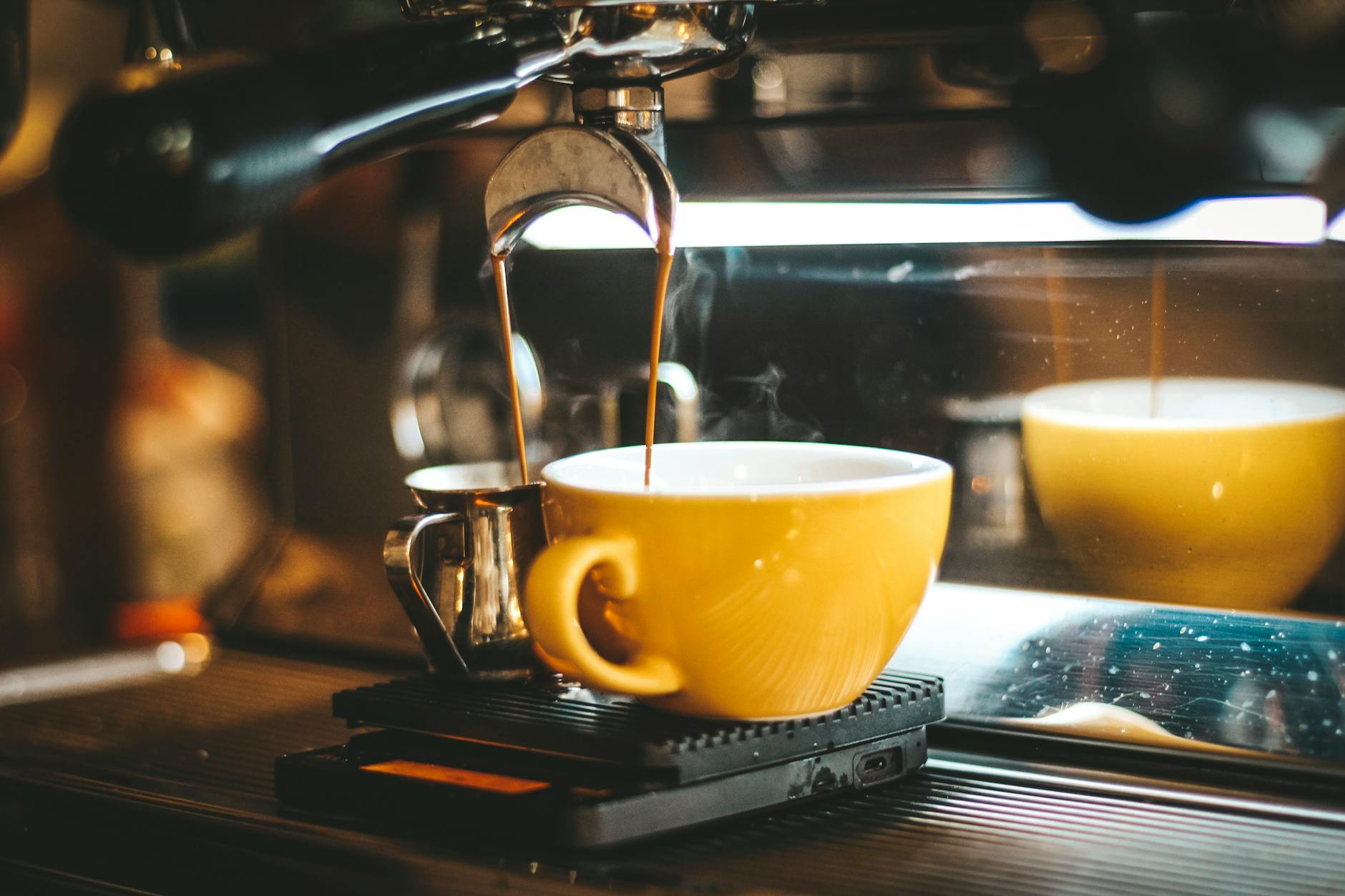 A sleek, top-rated fully automatic espresso machine with a latte being prepared, showcasing its premium features and modern design in a home kitchen setting.