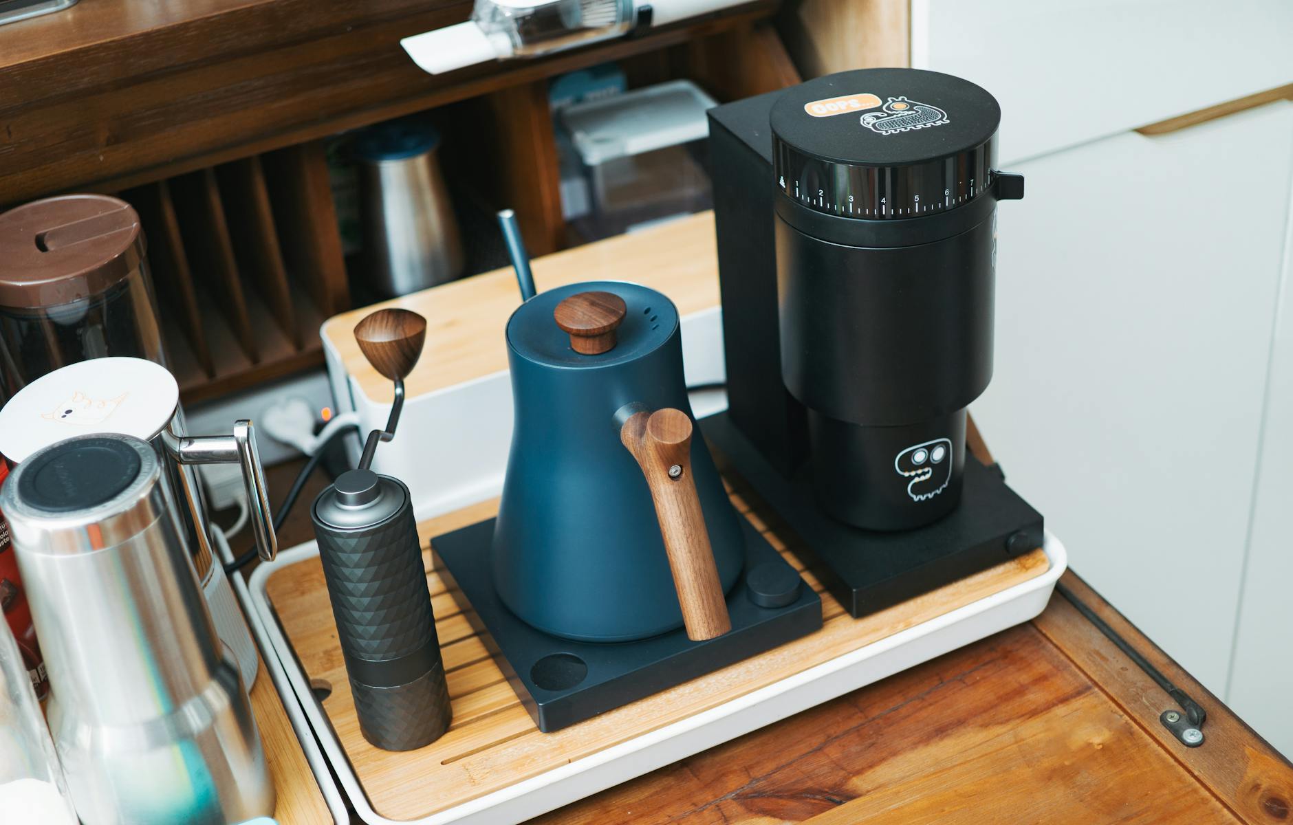 A lineup of diverse coffee grinders, from a compact manual grinder to a sleek electric mid-range model, demonstrating options for every budget.
