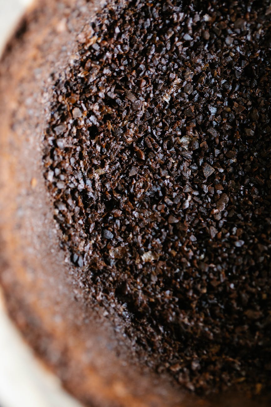 A close-up shot of freshly ground coffee from a high-quality burr grinder, showcasing uniform particle size perfect for pour over brewing.